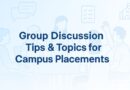 Banner with the title 'Group Discussion Tips & Topics for Campus Placements' in dark blue font, set on a soft light blue gradient background with line illustrations of students in a group discussion, speech bubbles, checklists, and a campus building icon.